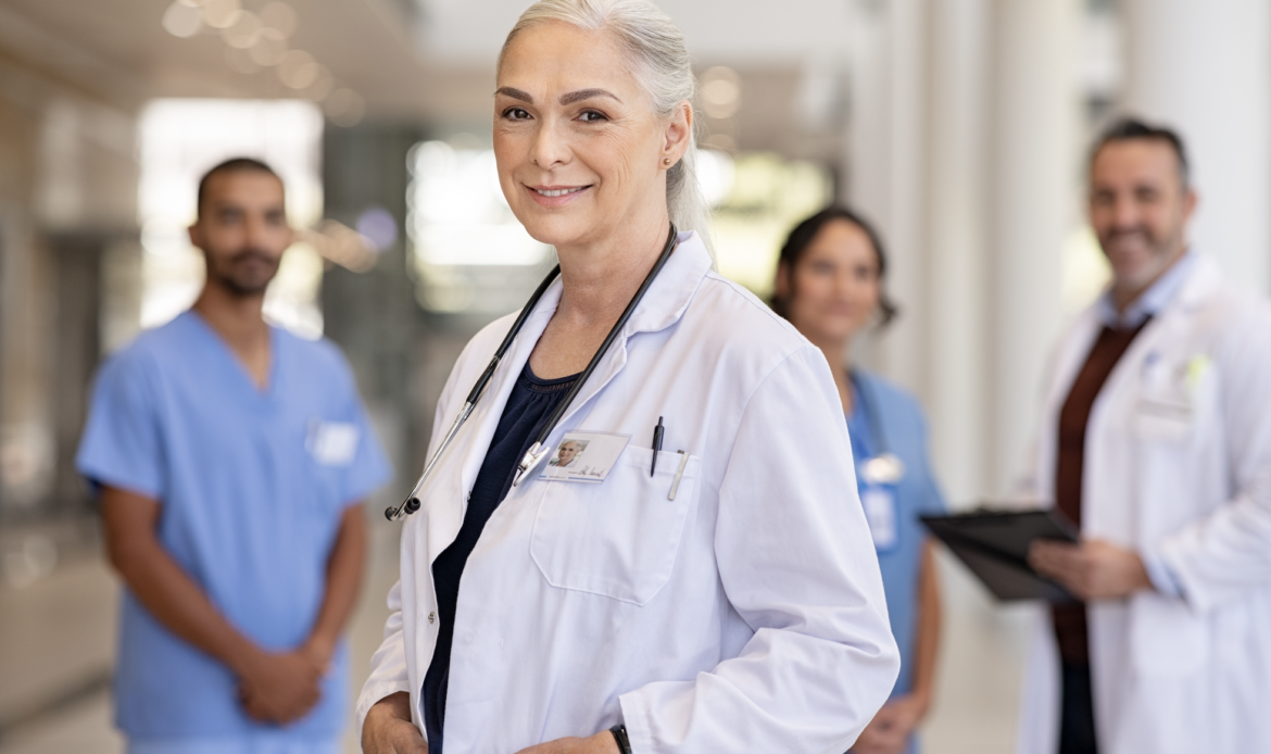 Doctors stands with other healthcare professionals, doctors, and nurse practitioners